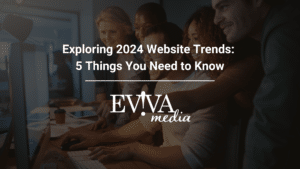 Group of people working at a computer, text overlay "Exploring 2024 Website Trends: 5 Things You Need to Know" and "EVIVA media" logo.